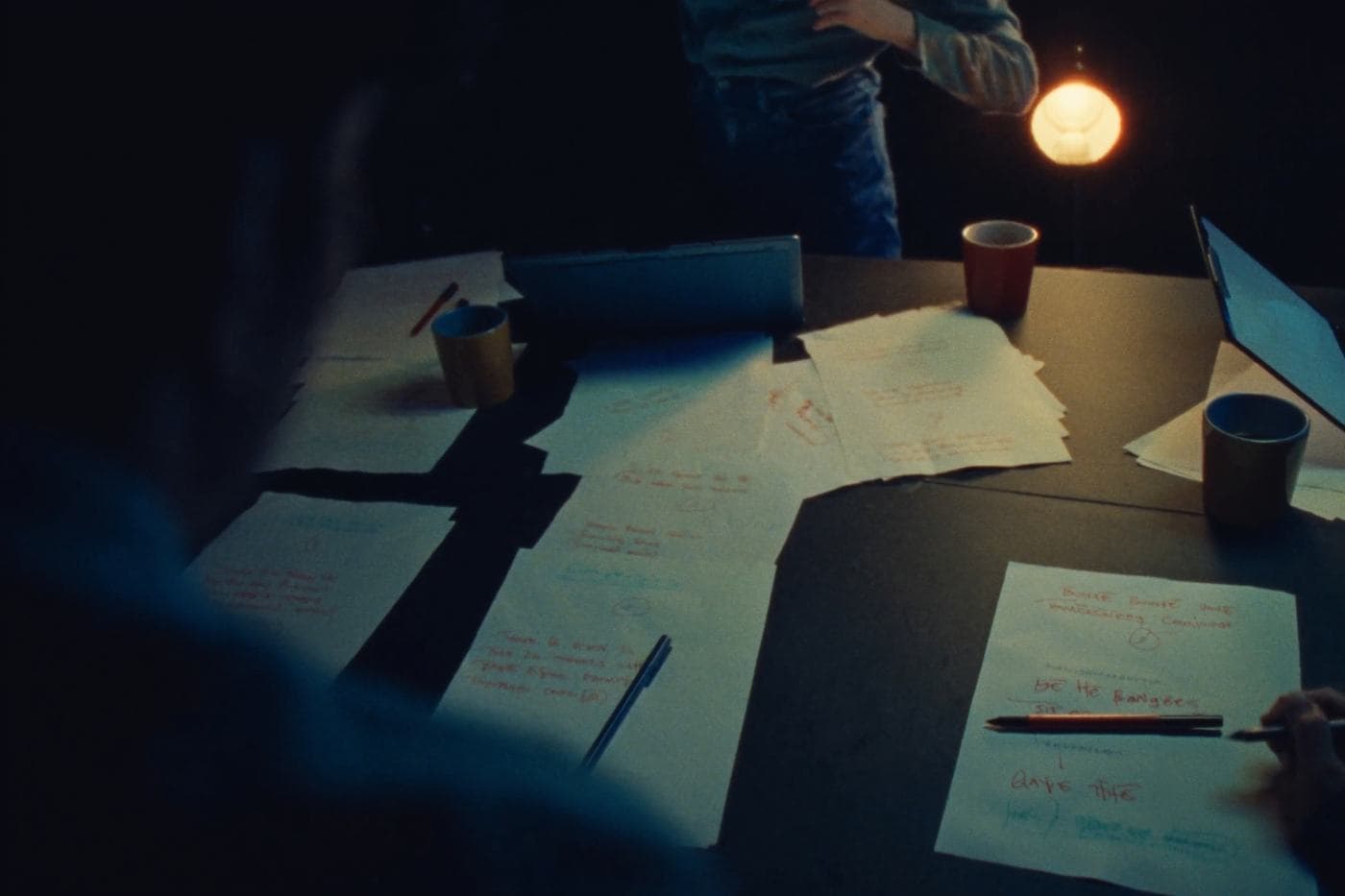 Marked-up practice passages on a shared worktable at night